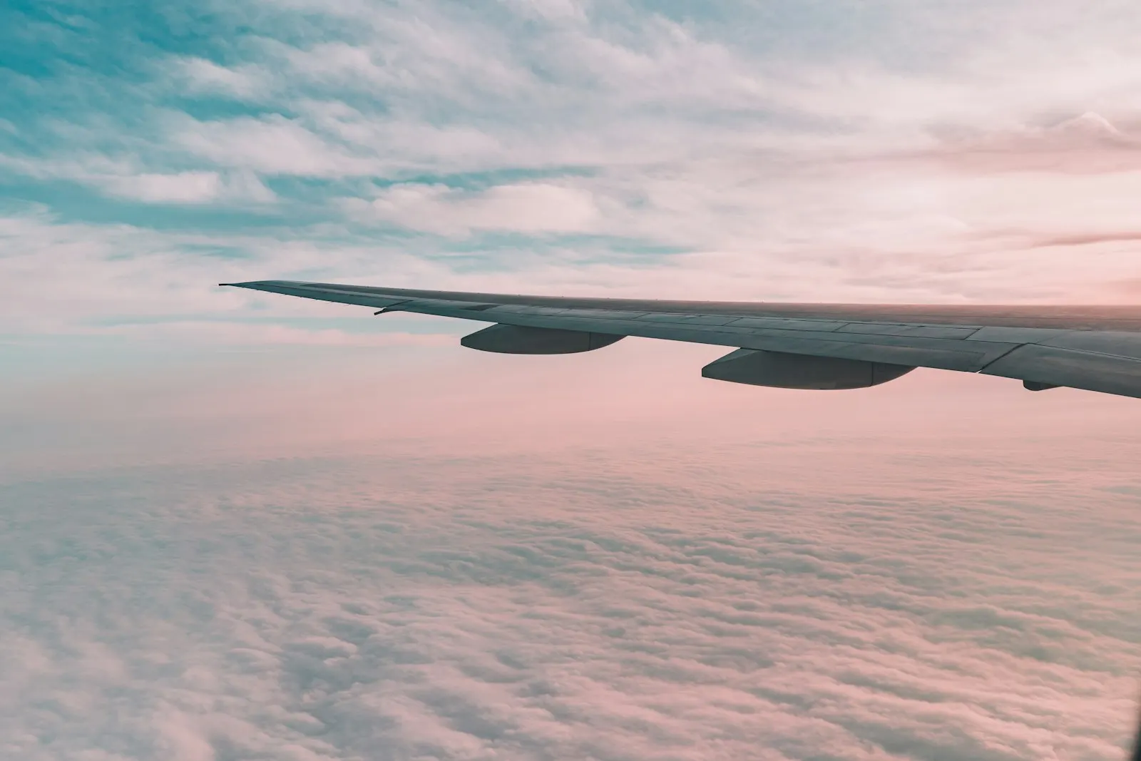 Flying plane above sky white plane wing: contact OYG Holidays